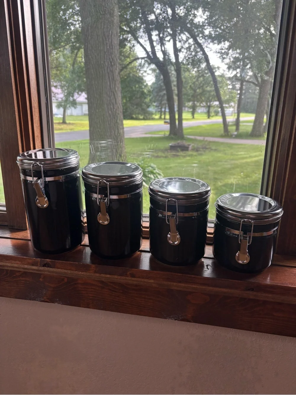 Set of 4 Black Airtight Kitchen Canisters with Silver Accents